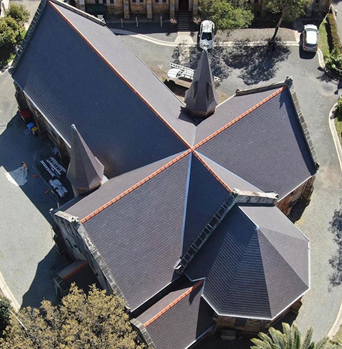 An aerial shot from above showing a fully restored tile roof of a large church